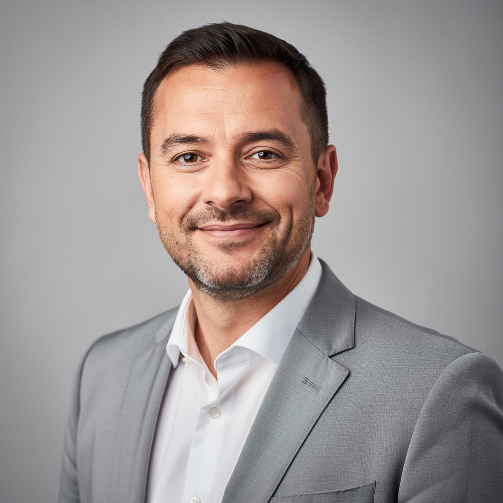 Studio portrait of a Belgian man in business attire smiling